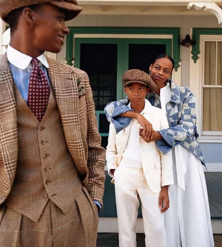 Group of models in patterned tweed suits and casual wear posing outdoors on a porch for Polo Ralph Lauren Oak Bluffs campaign.
