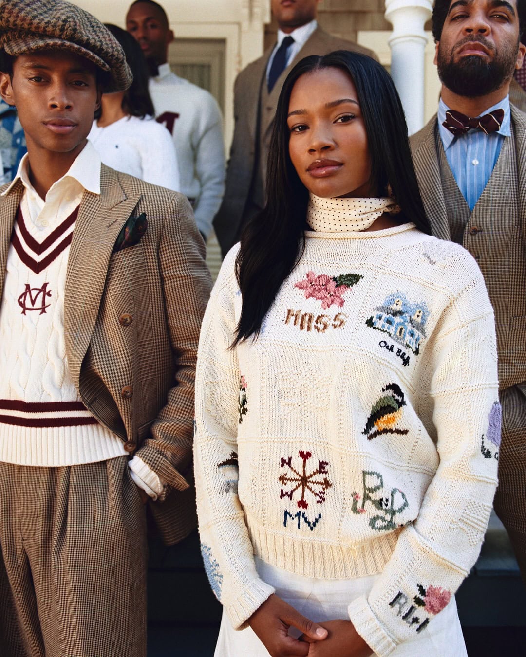Group of diverse models wearing tailored heritage clothing and embroidered knitwear outdoors by Nadine Ijewere.