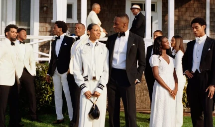 Group of people in formal attire and tuxedos gathered outside a traditional wooden house for Polo Ralph Lauren Oak Bluffs campaign.