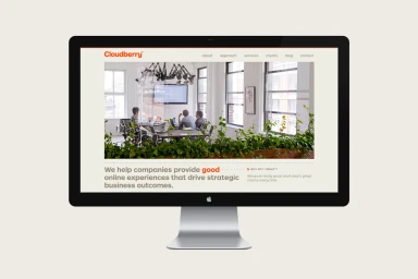 Desktop computer monitor displaying a website mockup for Cloudberry against a plain light background