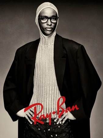 Model wearing eyeglasses and a netted hood with a black blazer for Ray-Ban