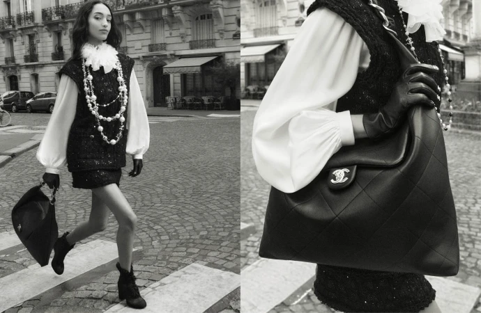 Model Mona Tougaard walking down a cobblestone street wearing a tweed vest and holding a large leather handbag in a Chanel campaign