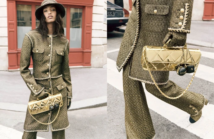 Model Mona Tougaard wearing a textured tweed coat and matching hat while holding a metallic gold quilted handbag on a city street.