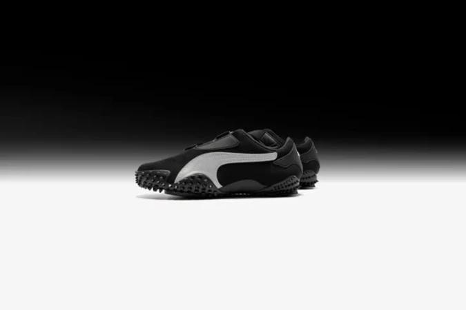 Puma Mostro sneaker in black with white side stripe on gradient background