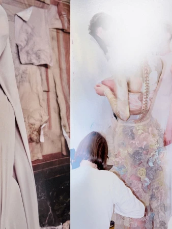 Model in a detailed sheer dress with floral appliqués being fitted backstage during a Maison Margiela Artisanal campaign shoot.