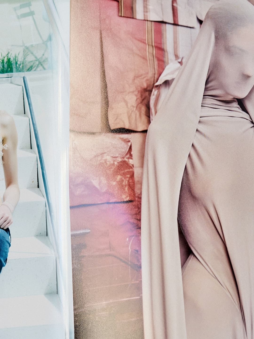 Model draped in beige fabric with face covered standing in front of a draped backdrop for Maison Margiela Artisanal Fall 2025 campaign