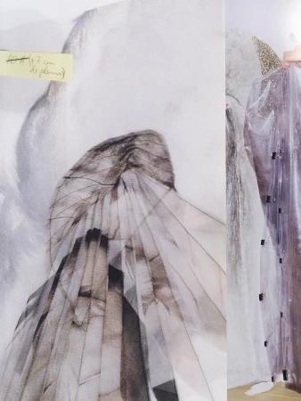 Layered translucent textile art piece with sketched figure details and a yellow sticky note
