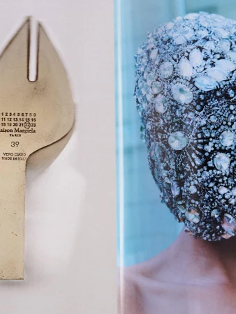 Close-up of a shoe sole bearing the Maison Margiela numeric logo beside a heavily embellished crystal headpiece