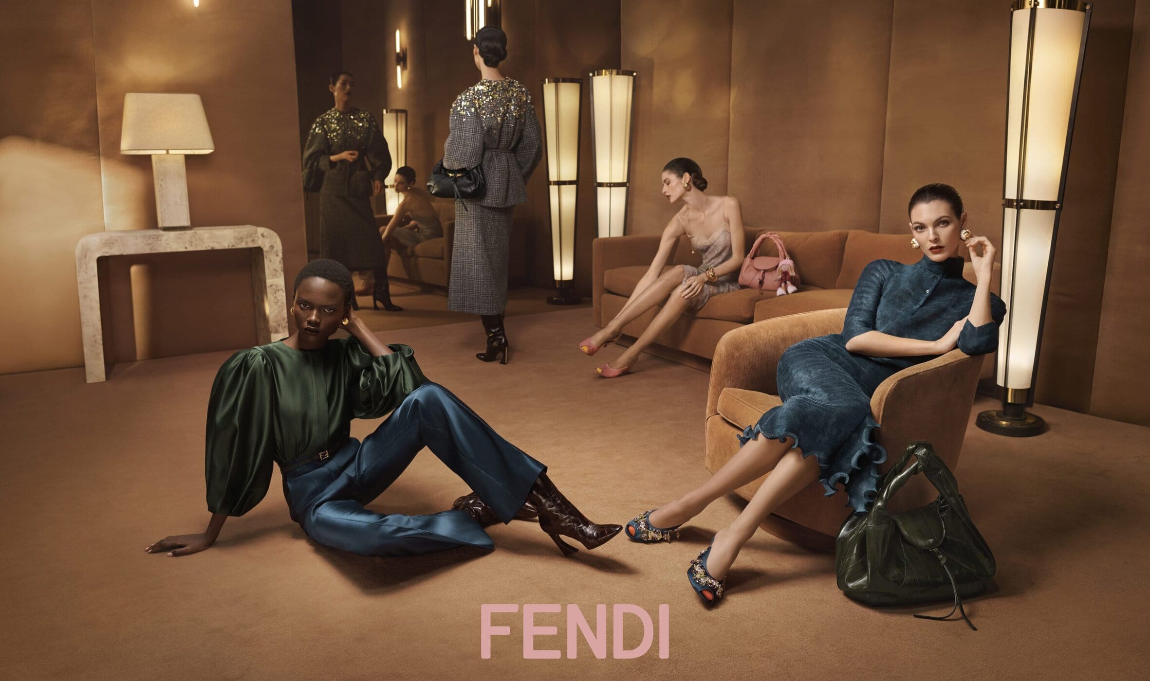 Models posed in a warm toned interior setting for the Fendi Fall 2025 ad campaign photographed by Steven Meisel