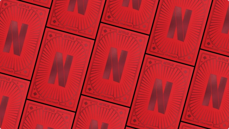 Red playing cards with Netflix N logo and sunburst graphic pattern scattered across a dark red surface