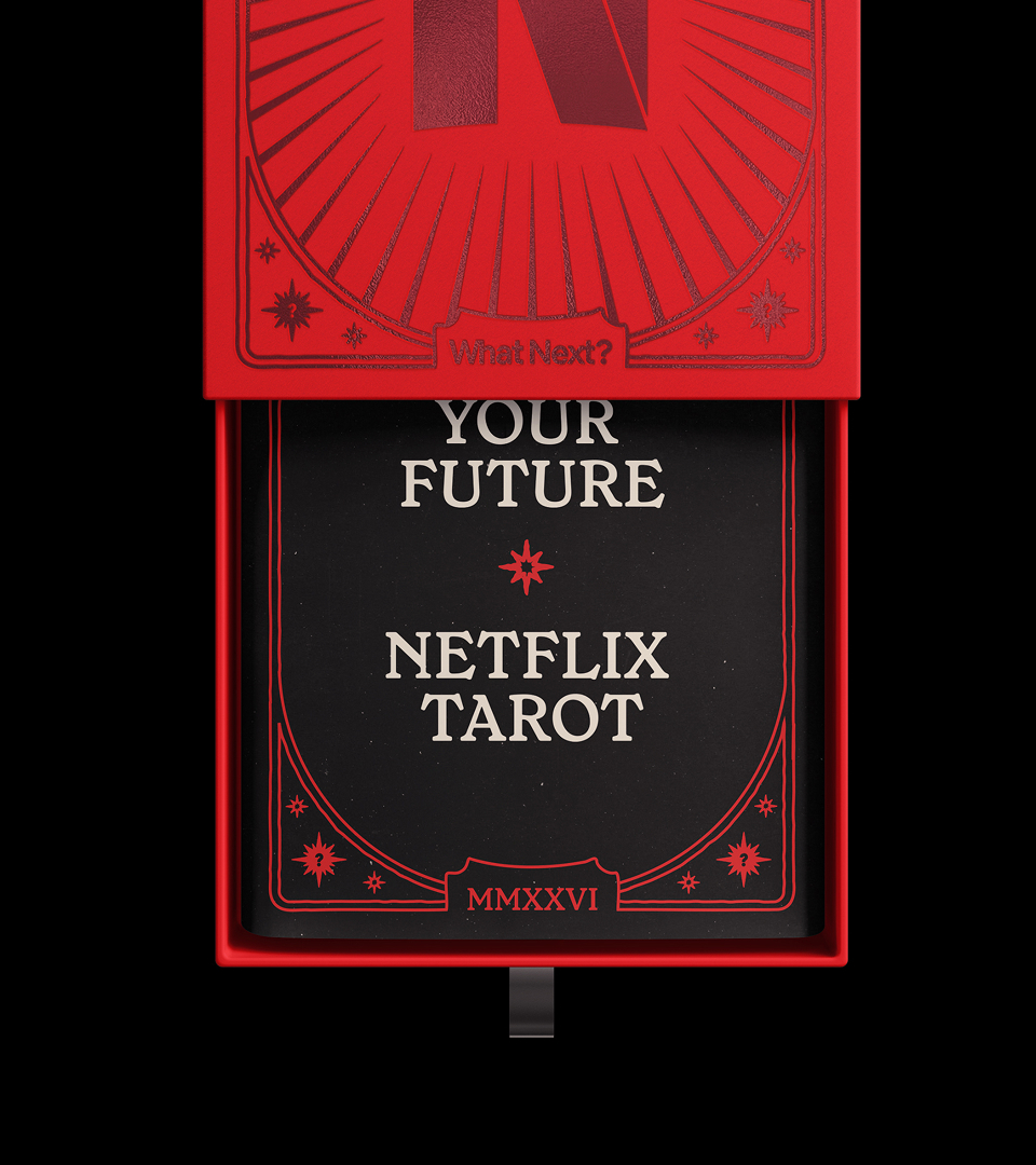 Top-down view of a bright red box containing a black card with white typography reading YOUR FUTURE NETFLIX TAROT.