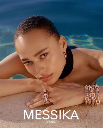 Model wearing diamond jewelry resting hands near an outdoor pool for Messika Summer 2025 campaign