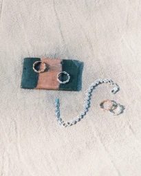 Messika diamond jewellery pieces displayed on textured sand and a stone block for the Summer 2025 campaign.