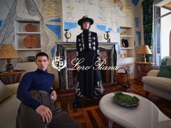 Two models posing in a living room with frescoed walls for the Loro Piana Fall 2025 ad campaign, photographed by Mario Sorrenti.