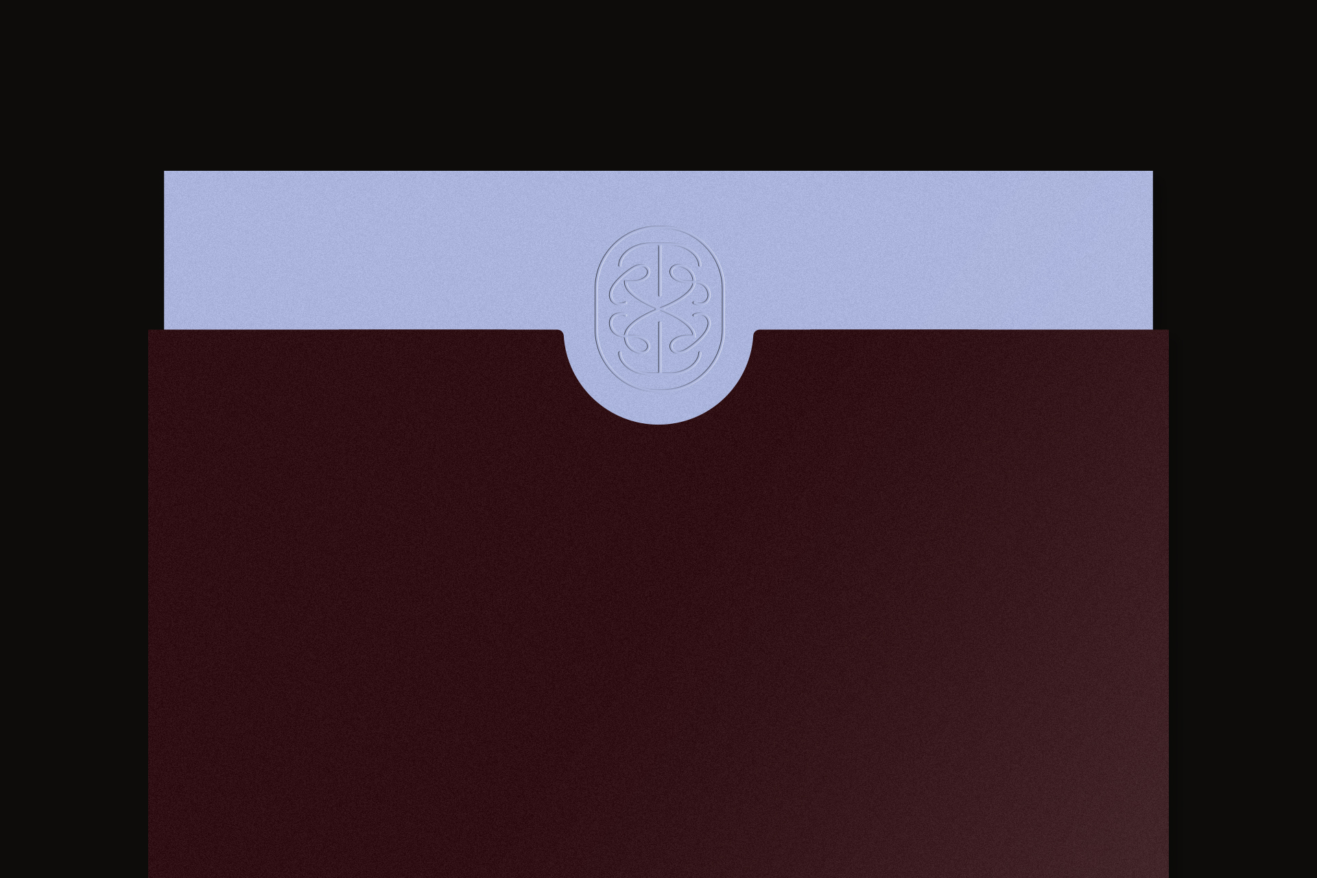 Embossed monogram logo centered on a light lavender card inserted into a dark burgundy envelope against black.