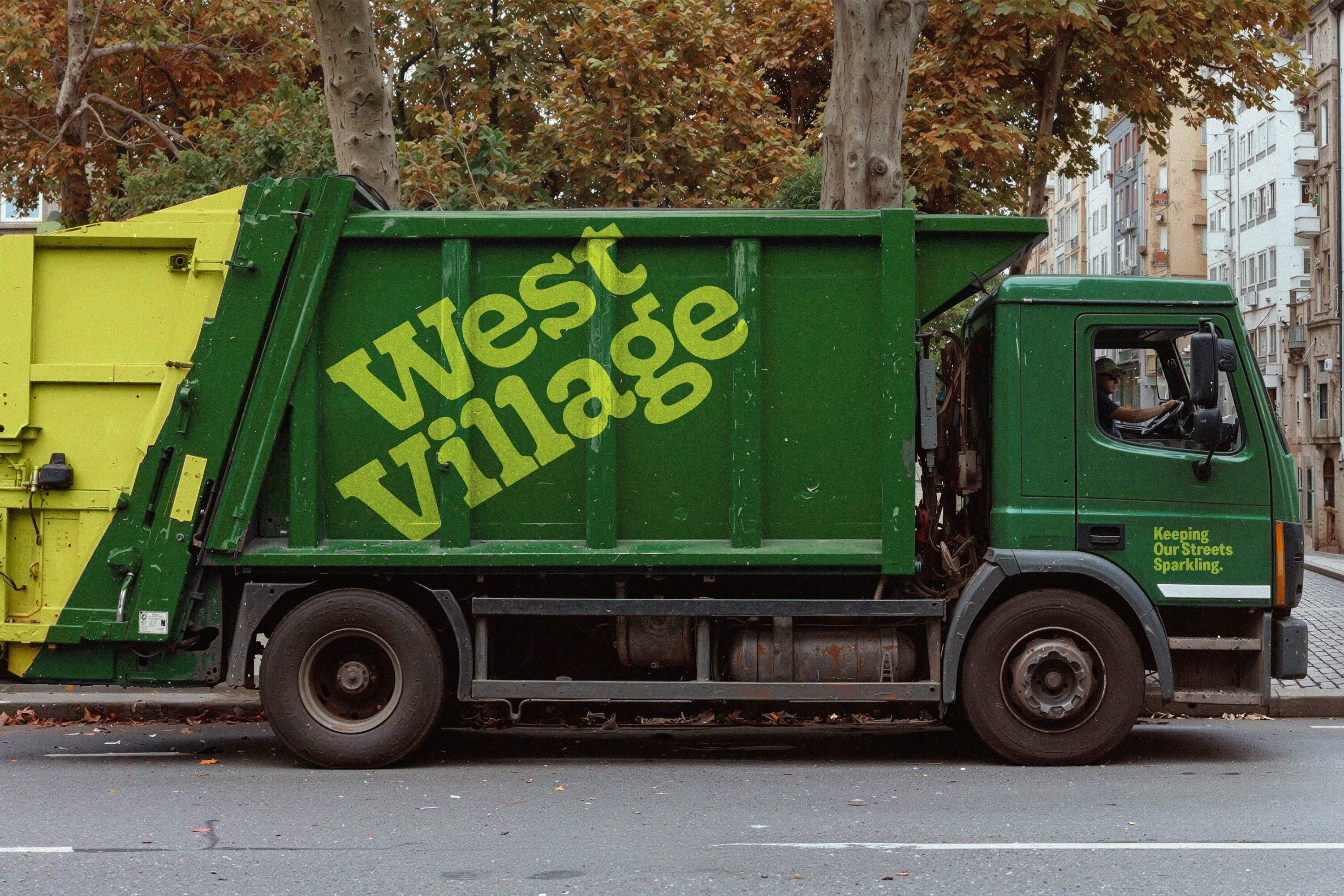 Green sanitation truck parked on a city street with bold typography on the side for West Village Partnership.