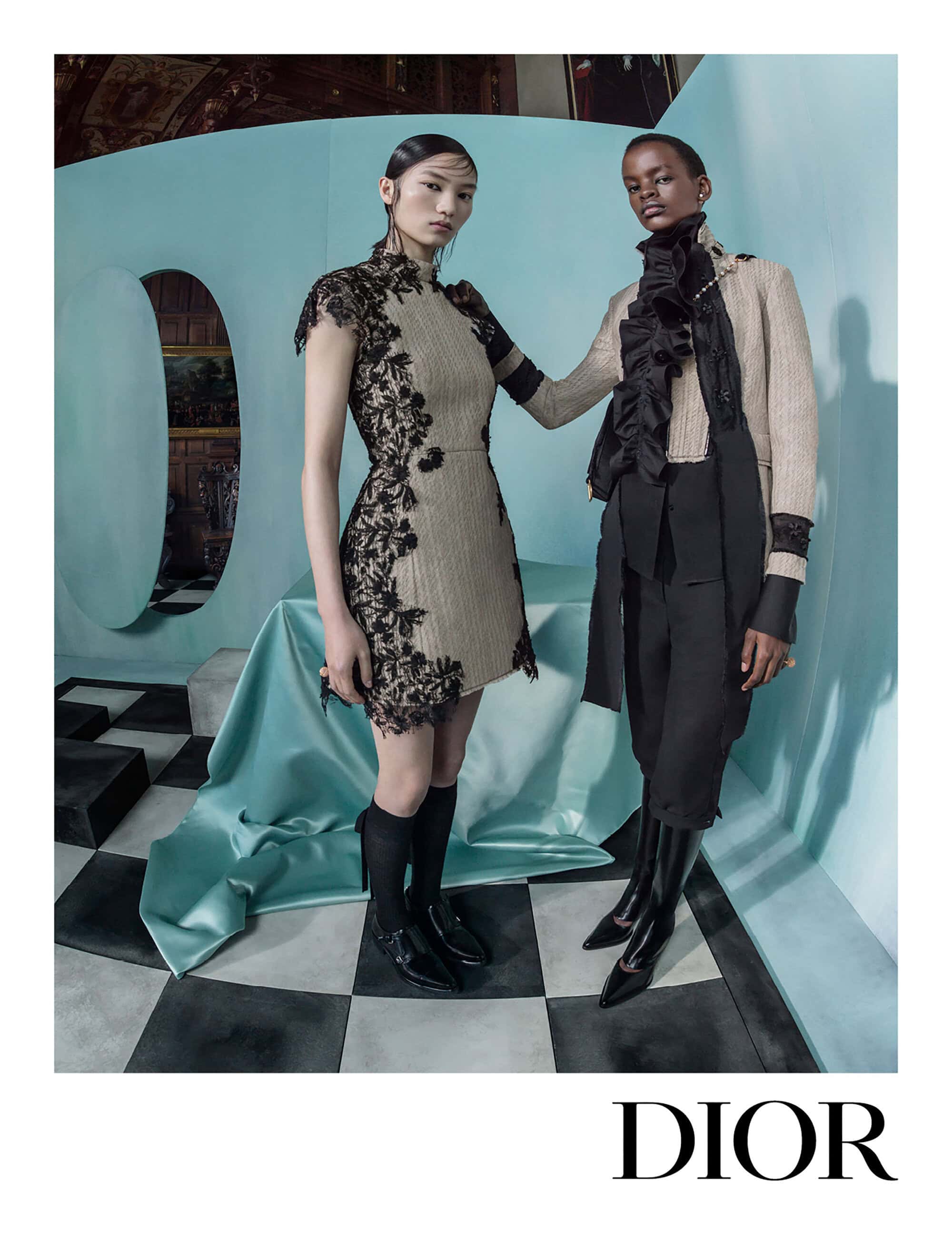 Two female models wearing Dior collection pieces inside a surreal turquoise room with a black and white checkerboard floor