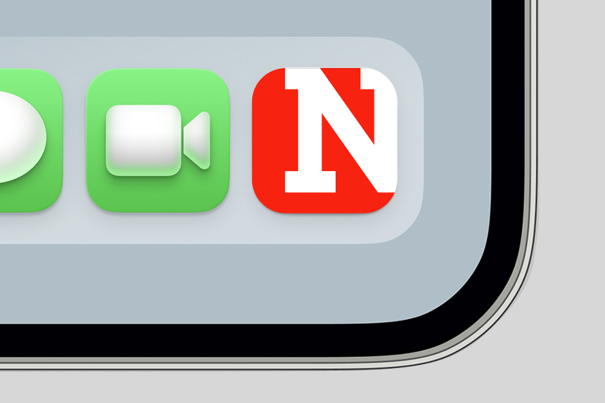 Close-up of a mobile screen showing digital app icons including a red square icon with a white letter N.
