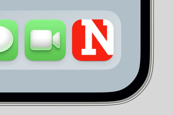 Close-up of a mobile screen showing digital app icons including a red square icon with a white letter N.