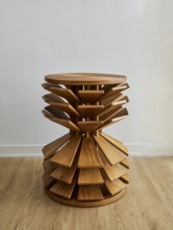 Sculptural wooden stool with radial fin design set against a pale wall and wooden floor for Hello Human and Lyle Gallery brand identity.