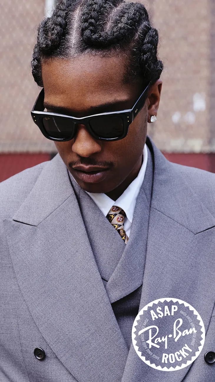 A$AP Rocky wearing black Ray-Ban sunglasses and a grey suit for an ad campaign
