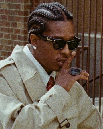 ASAP Rocky wearing Ray-Ban sunglasses and a beige trench coat for an advertising campaign