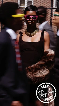 Woman in pink sunglasses and gold chain necklace holding fur stole for Ray-Ban ad campaign