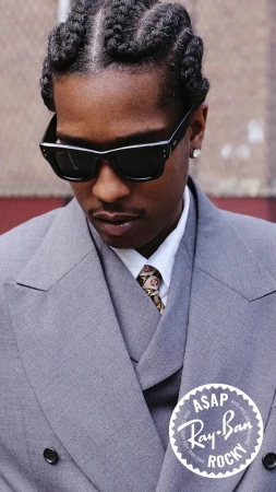 A$AP Rocky wearing black Ray-Ban sunglasses and a grey suit for an ad campaign