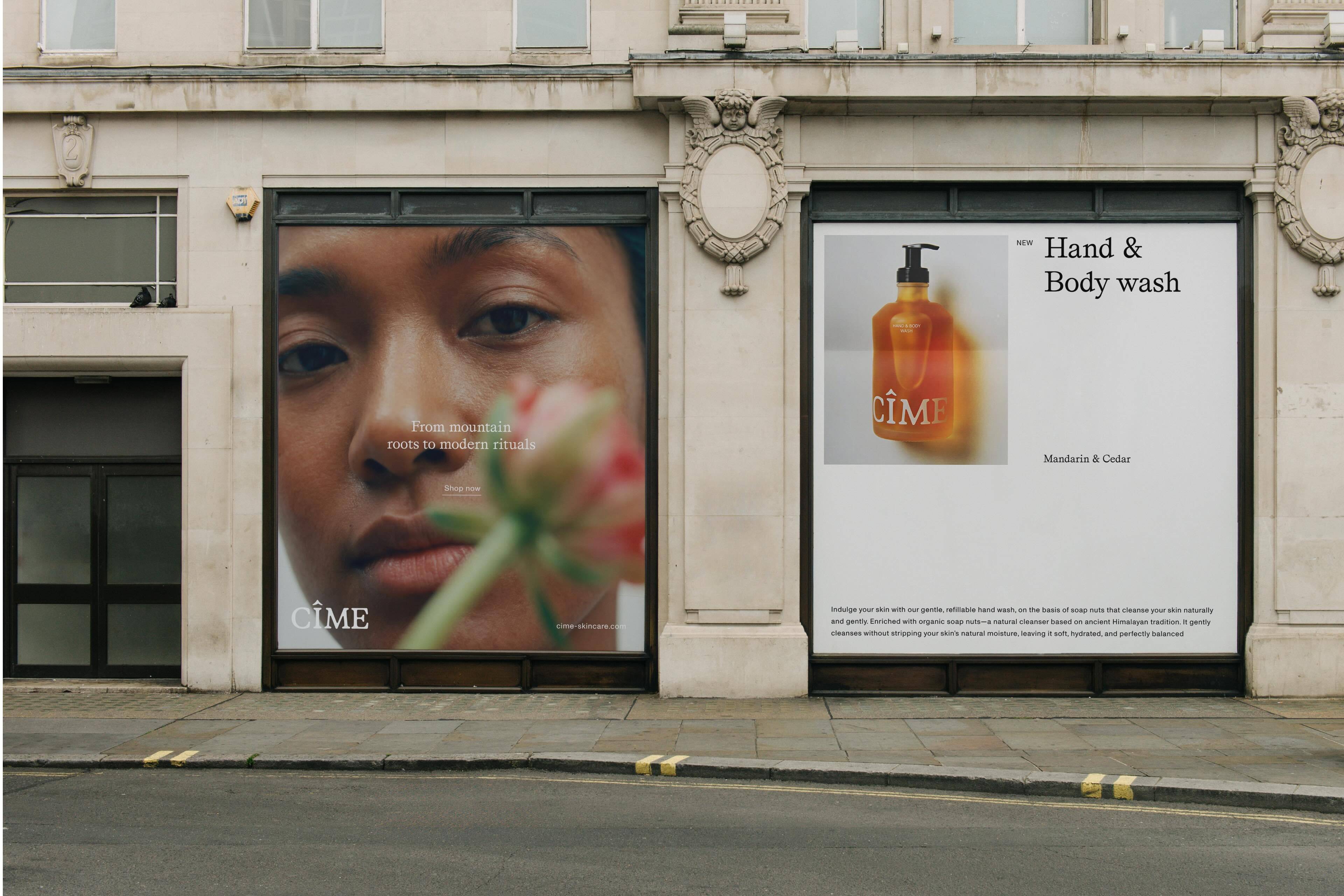 CIME skincare advertising displayed on large store windows of a classic stone building facade with a street in the foreground.