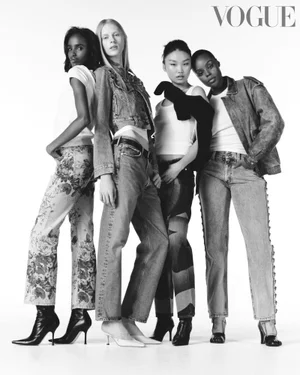Four female fashion models in denim and white t-shirts posing against a bright white background for a British Vogue x Ebay editorial