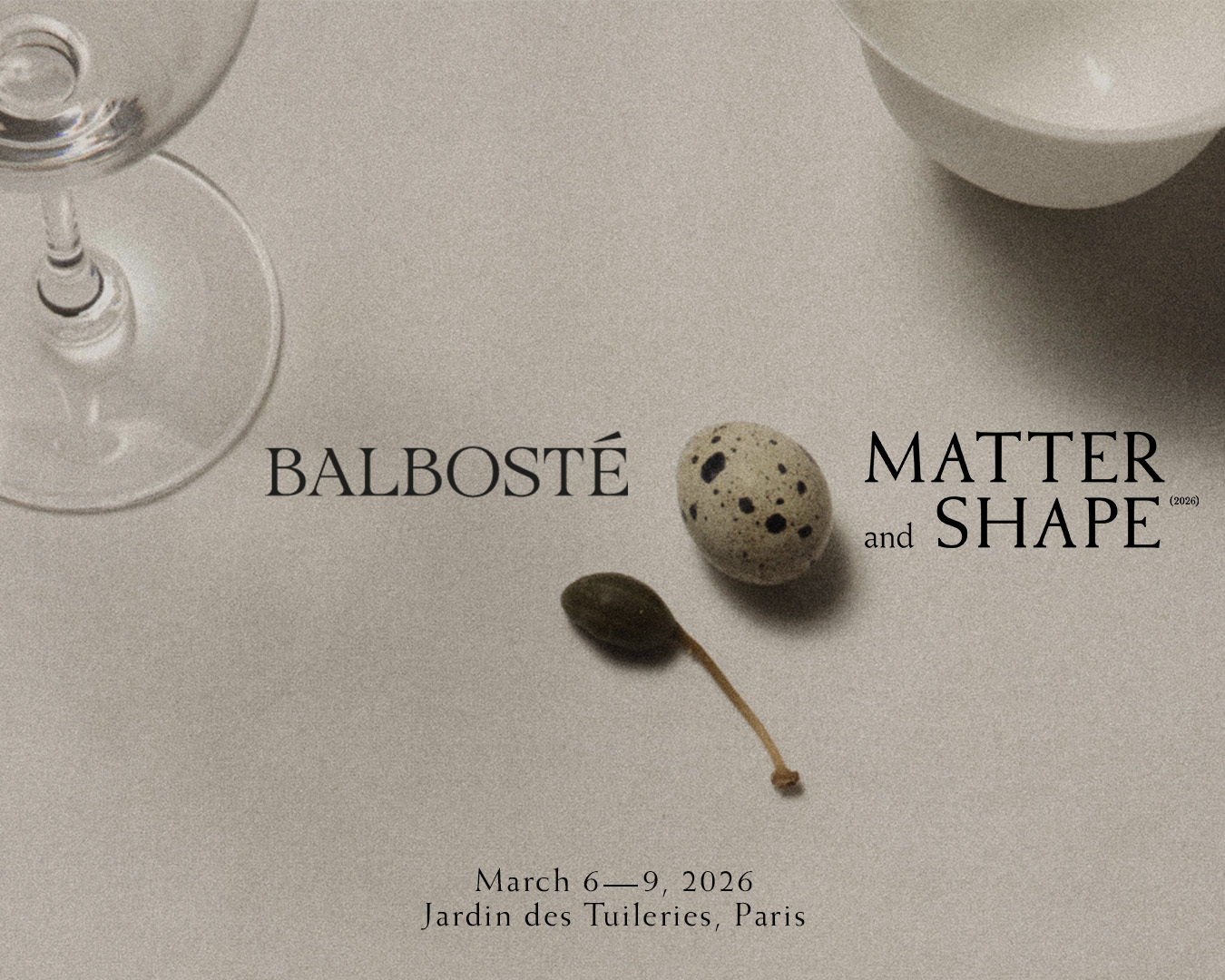 Quail egg and caper berry on a textured neutral surface with typography for Matter and Shape by Balbosté