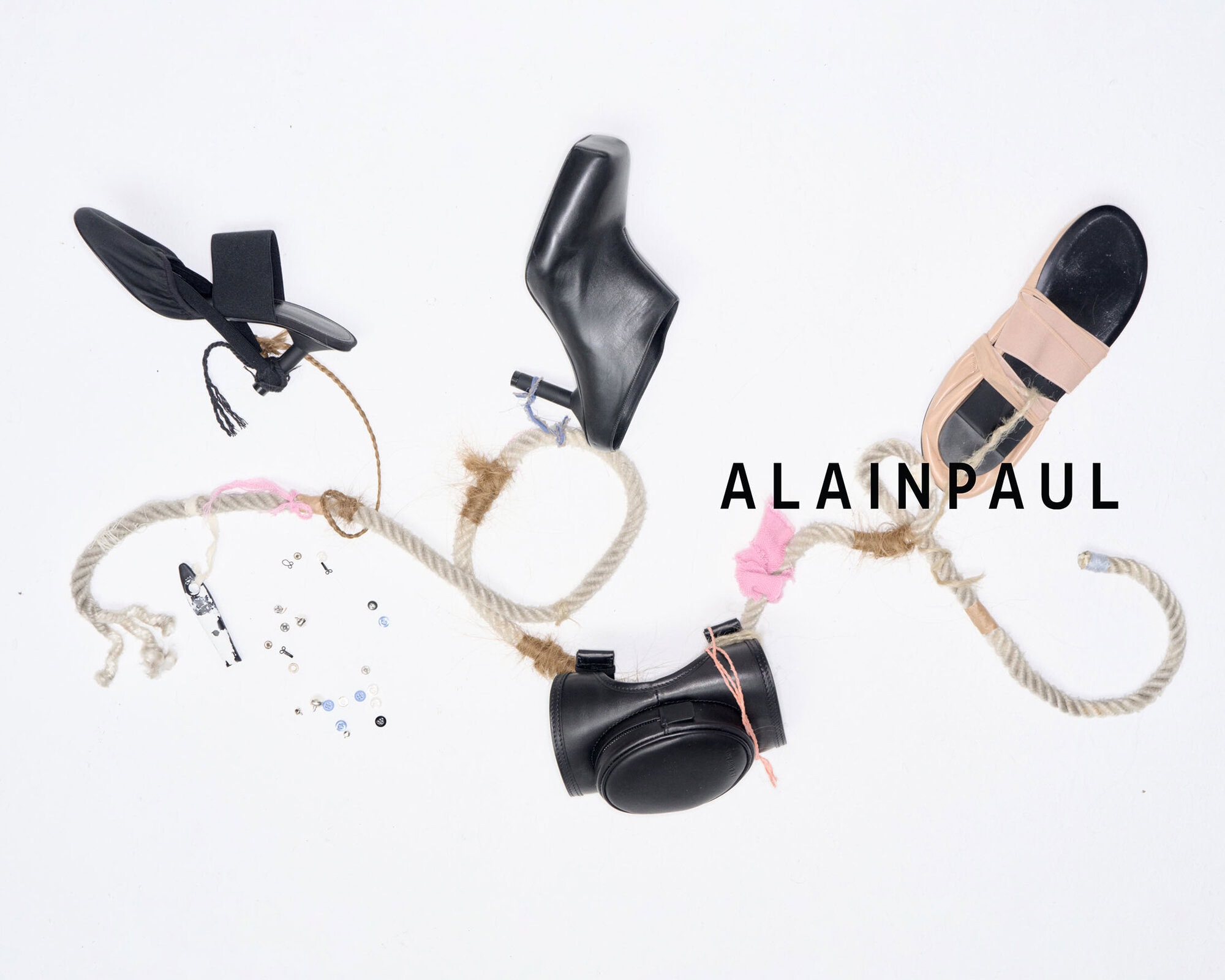 Alainpaul footwear campaign image featuring leather shoes and sandals arranged with rope on white seamless background