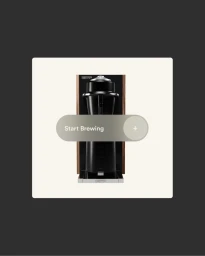 A black commercial coffee machine centered on a pale background with an interactive start brewing slider overlay.