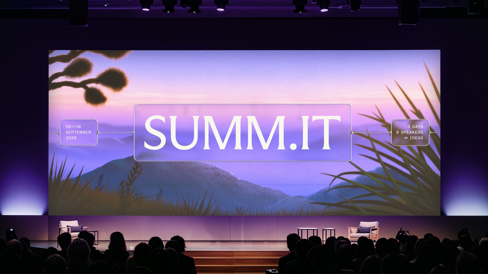 Large stage screen displaying a purple landscape illustration with the bold white text SUMM.IT before a seated audience.