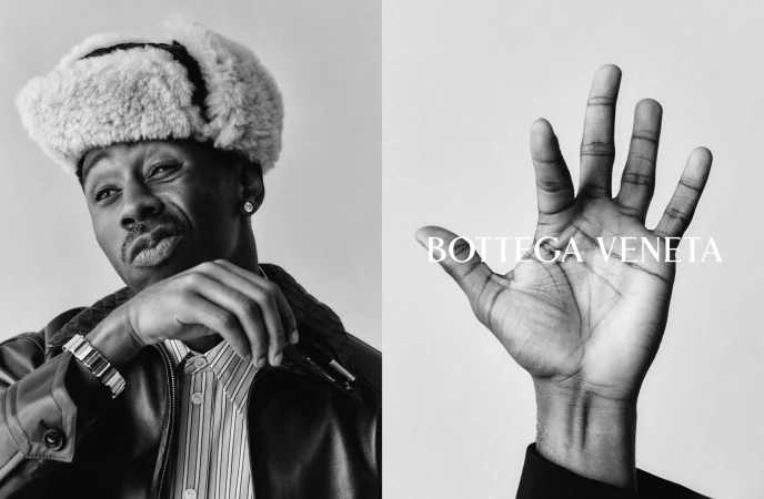 Black-and-white portrait of Tyler Okonma wearing a shearling trapper hat and leather jacket, alongside an open hand with Bottega Veneta text