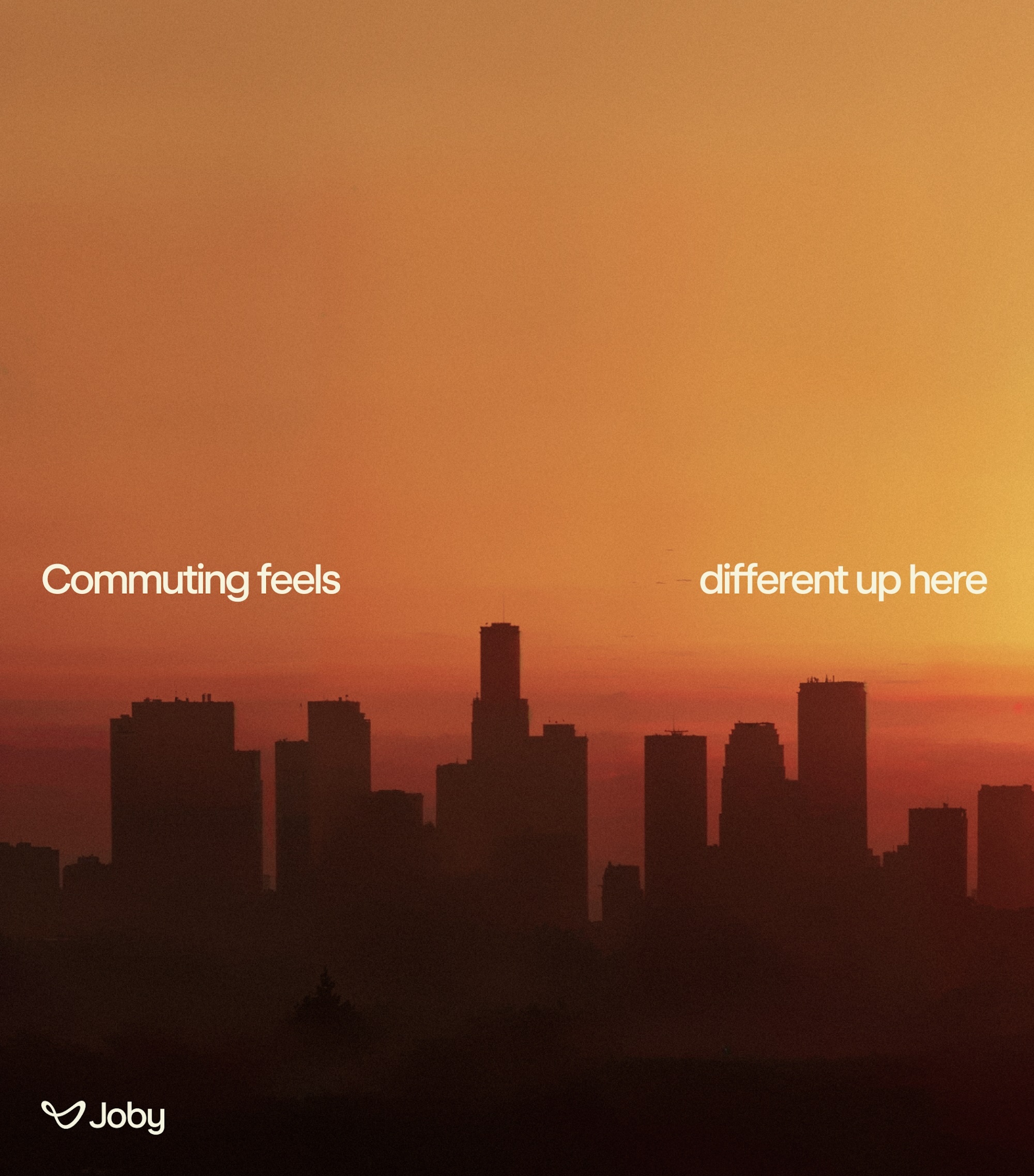 City skyline silhouetted against a warm orange sunset sky with bold white overlaid text