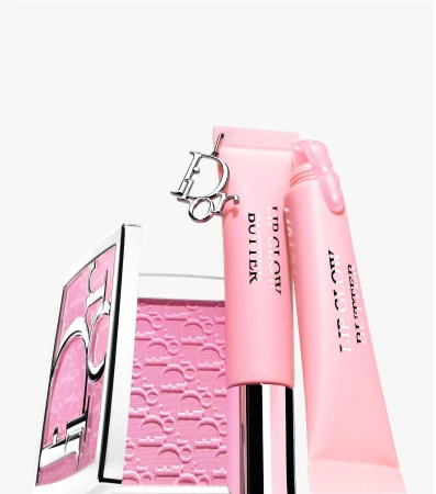 Pink Dior lip butter tubes and a compact case featuring the iconic monogram logo against a clean white seamless background.
