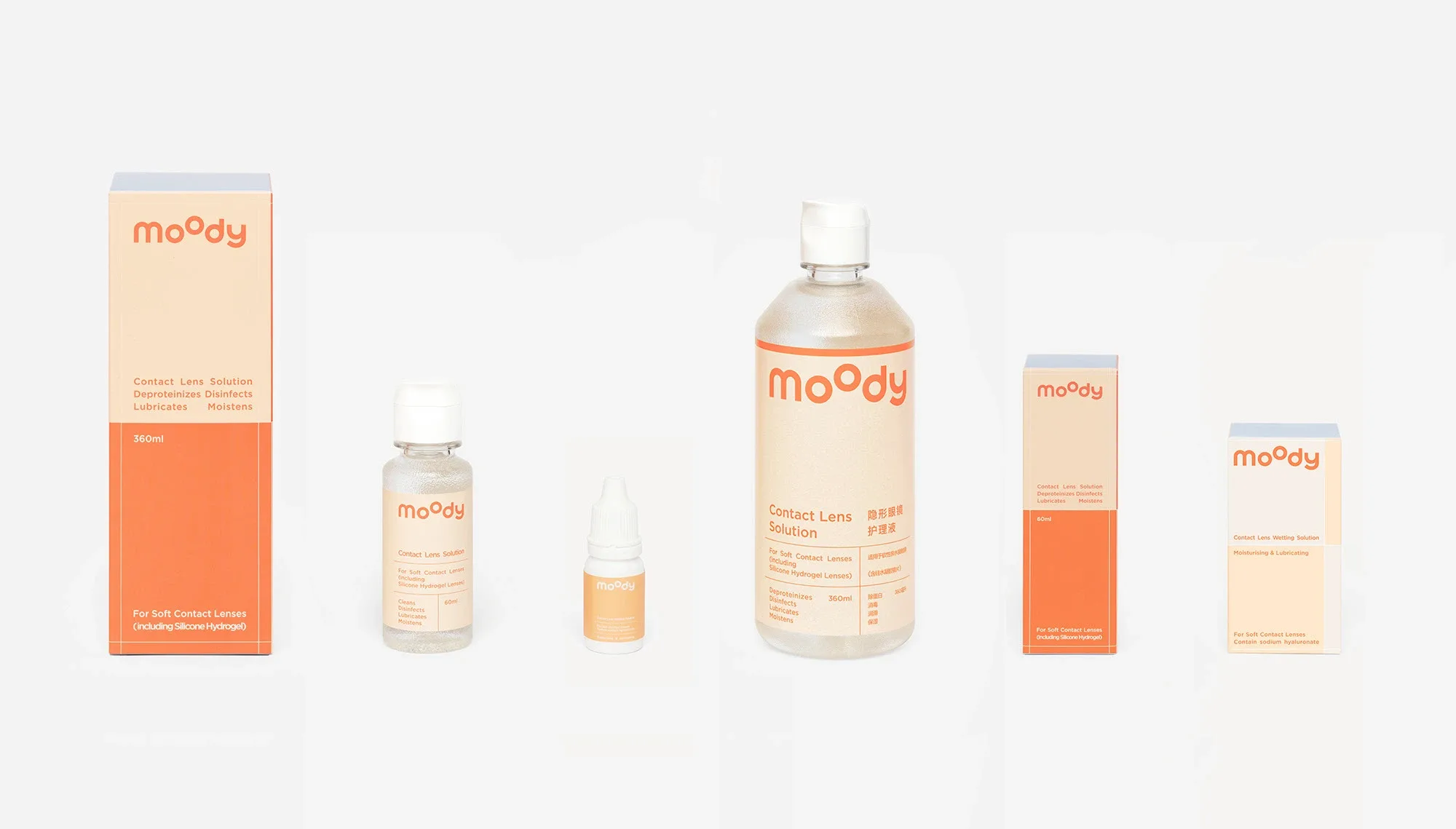 Product line-up of Moody contact lens solution bottles and matching paper boxes against a white background.