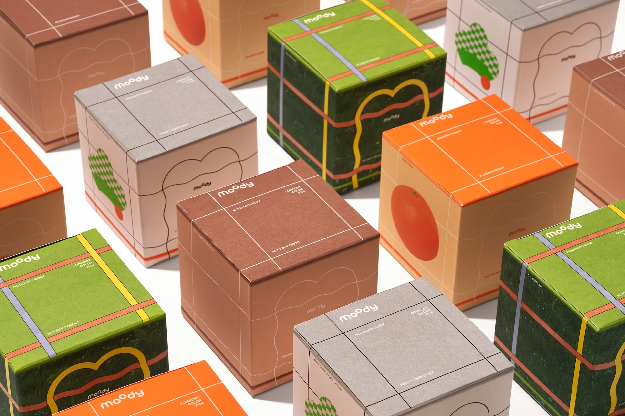 Arrangement of colourful branded packaging boxes featuring geometric lines, typography, and illustrations on white