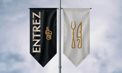Two vertical banners hanging from a metal pole against a cloudy sky, featuring the brand identity design for Chillon Castle.