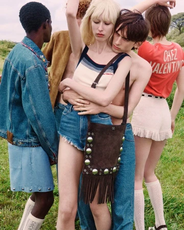 Group of four models posing in a grassy field for the Valentino Nellcôte Bag ad campaign, photographed by Julie Greve.
