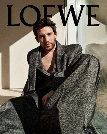 Josh O'Connor in a textured grey blazer and trousers against a neutral wall for Loewe Pre-Fall 2025 campaign photographed by Gray Sorrenti