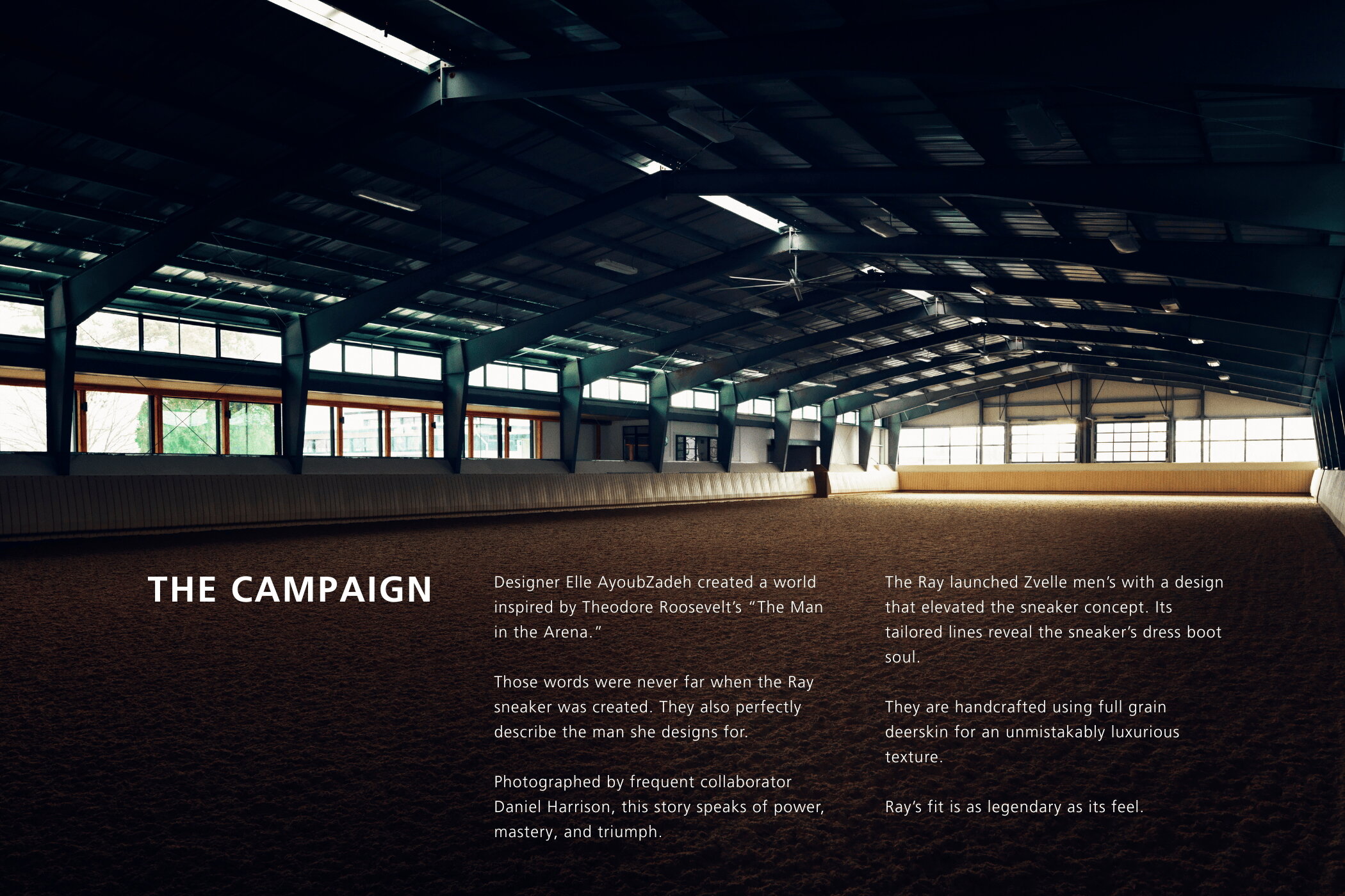 Wide interior view of a large indoor riding arena with dark exposed beams and sand flooring for Zvelle Spring 2025 ad campaign.