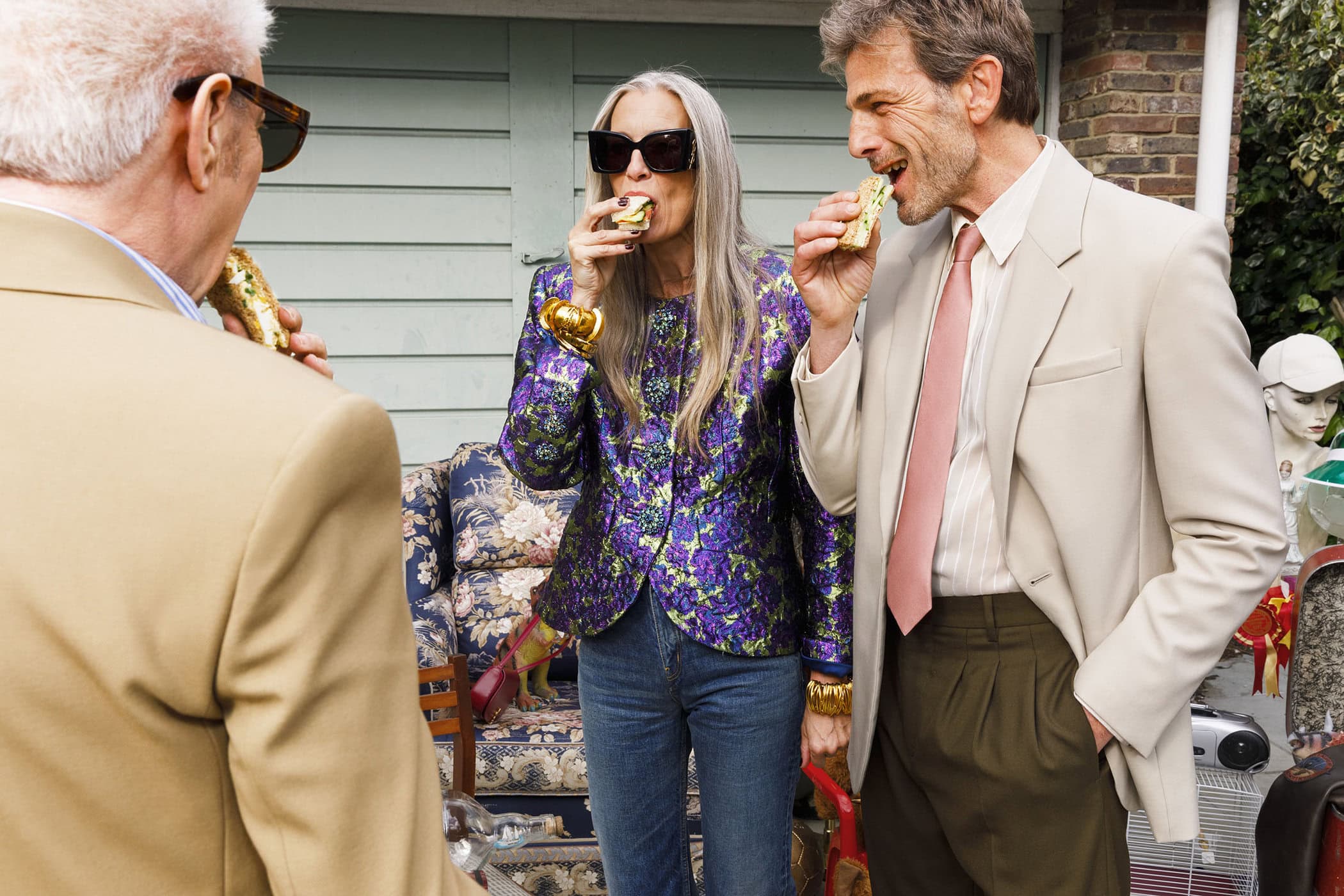Three models eating sandwiches outdoors in a casual setting for Saint Laurent An Ordinary Day ad campaign