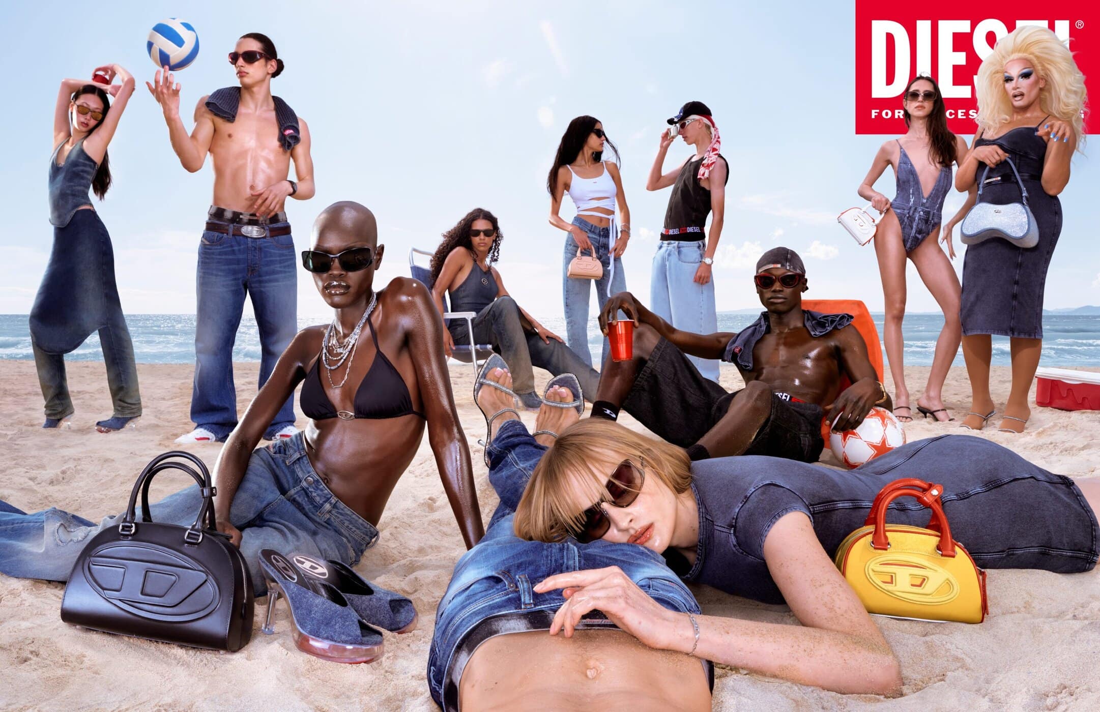 Group of diverse models in denim and swimwear on a sunny sandy beach for Diesel denim advertising campaign