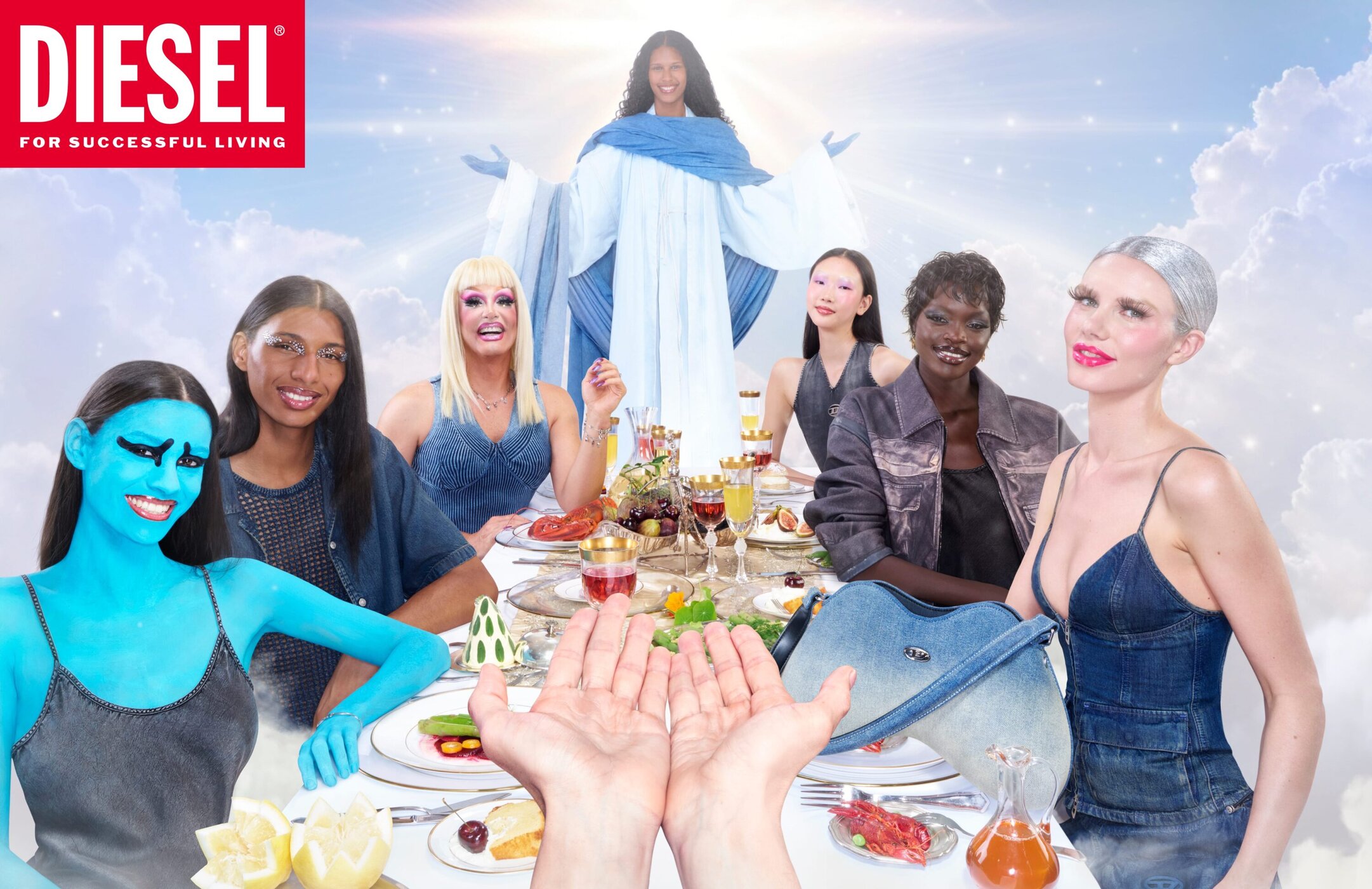 Diesel ad campaign featuring multiple models gathered around a long dining table against a cloudy sky background with a central angelic figure.