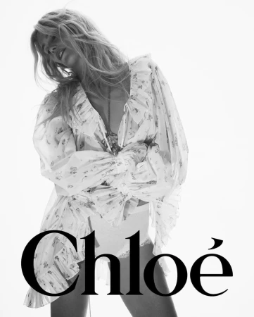 Model Claudia Schiffer in a white sheer ruffled blouse against a bright white background for Chloe
