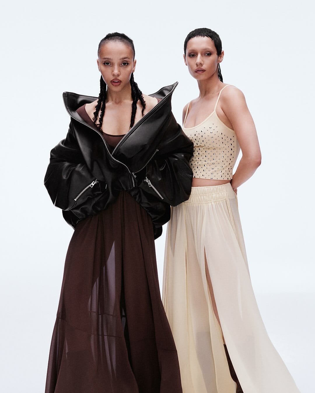 Two female models posing against a white studio background for the H and M Notes on Being campaign.