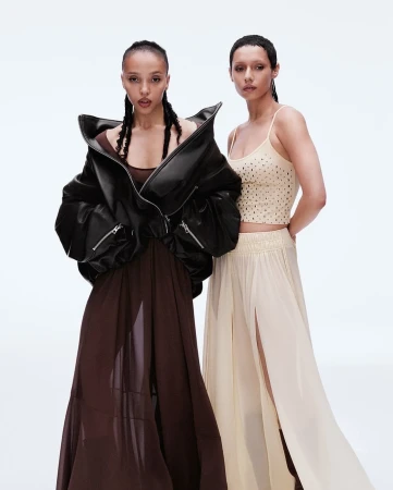 Two female models posing against a white studio background for the H and M Notes on Being campaign.