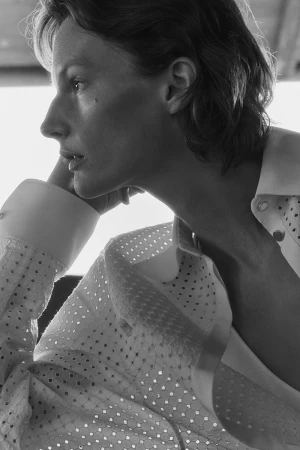Black and white portrait of Sara Blomqvist wearing a white eyelet button-down shirt for Giada Leisure campaign
